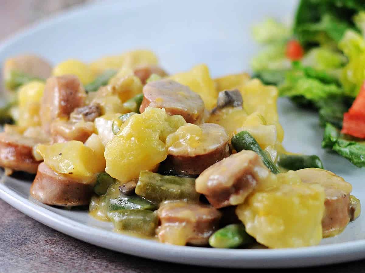 A serving of cheesy brat stew ready to eat.