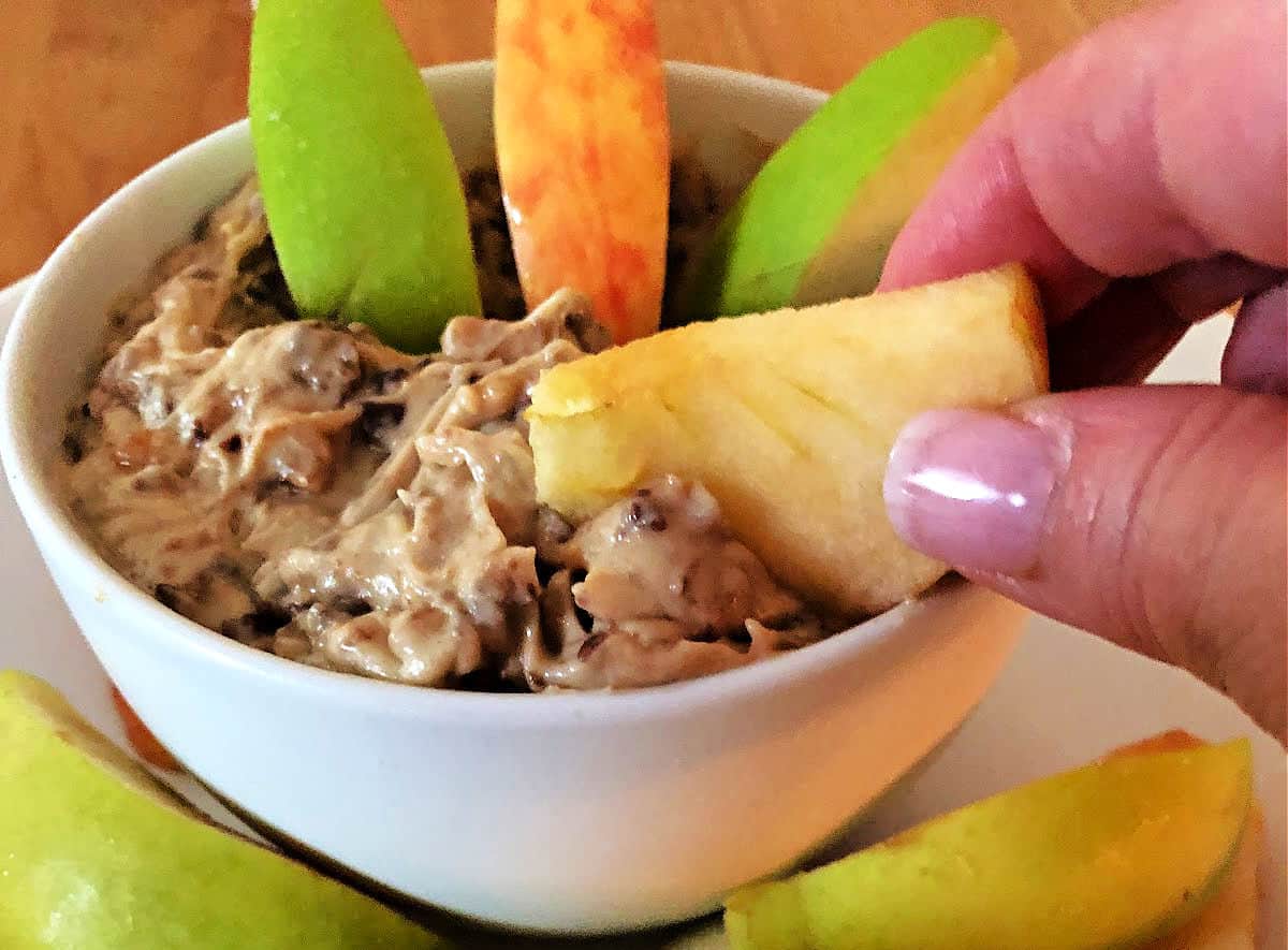 dipping an apple slice into the heath bar dip.