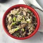 mushroom risotto in a small red bowl