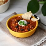Single bowl of taco chili with sour cream, ready to eat.
