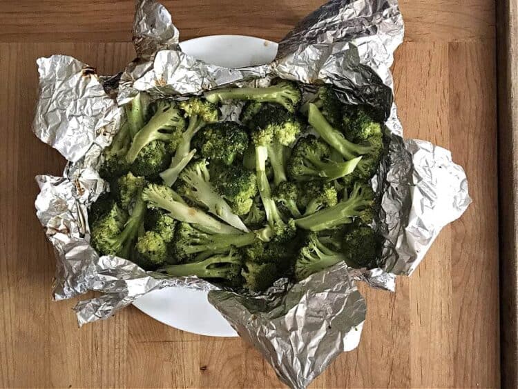 grilled broccoli in foil packet on a plate