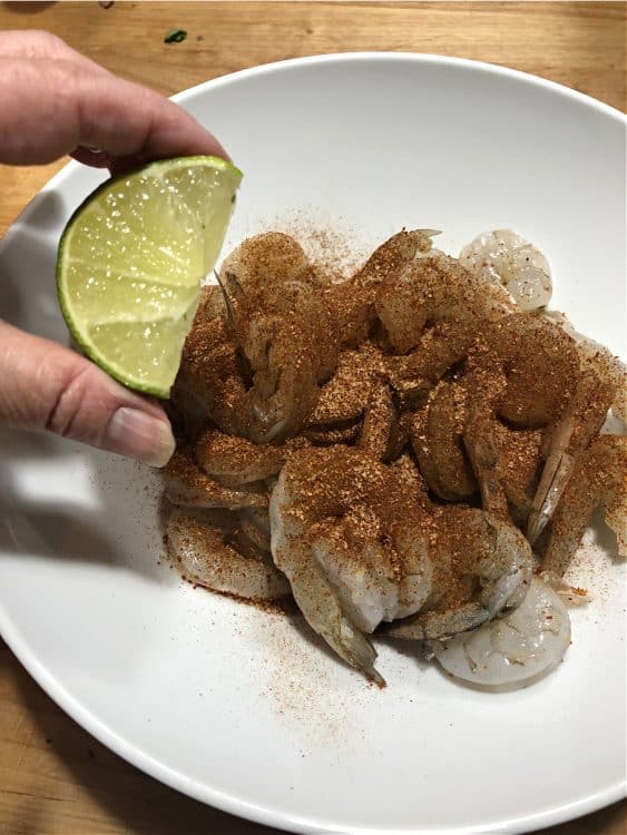 Squeeze a lime wedge into the bowl 