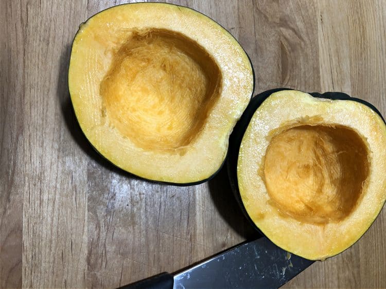 raw acorn squash cut in half