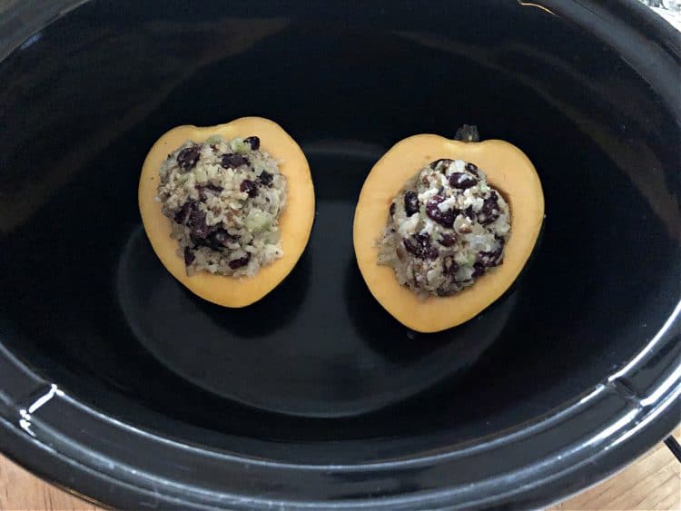 uncooked halves of stuffed squash in a slow cooker