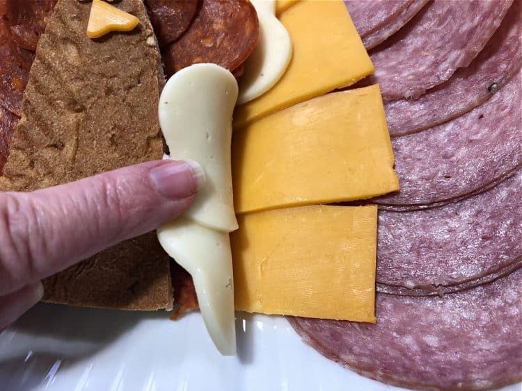 filling in layers of cheese and sausage