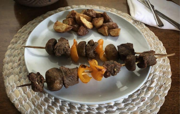Kabobs on a plate with potatoes