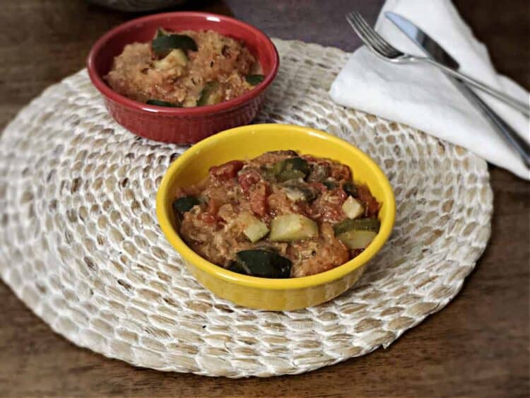 vegetarian spaghetti squash casserole in one red and one yellow bowl