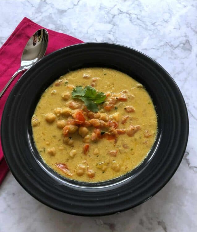 spicy chckpea tomato soup in a shallow bowl