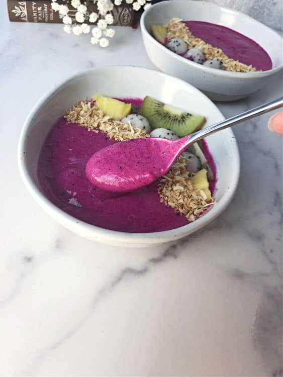 spoon scooping up some dragon fruit smoothie from a bowl