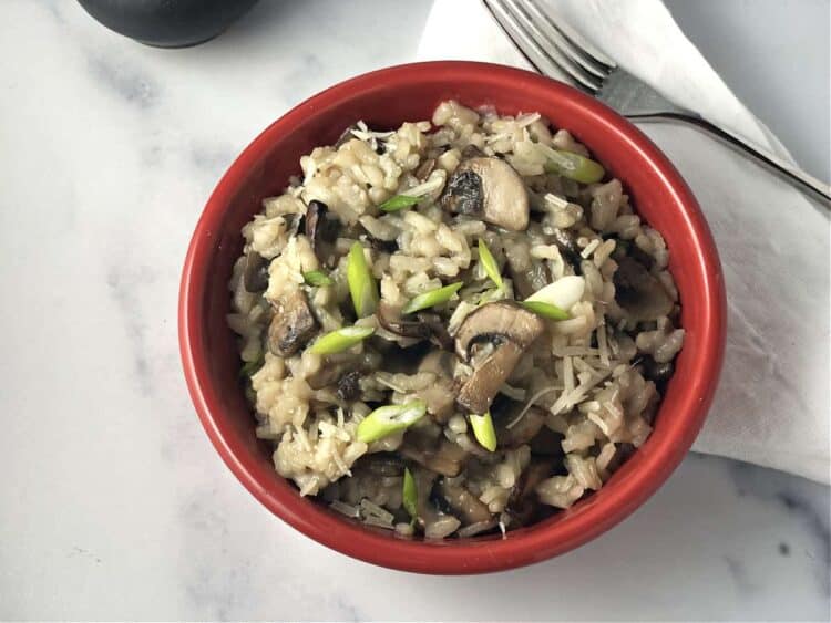 Mushroom risotto in a small red bowl