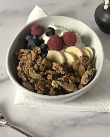 keto granola in a bowl with fruit and yogurt