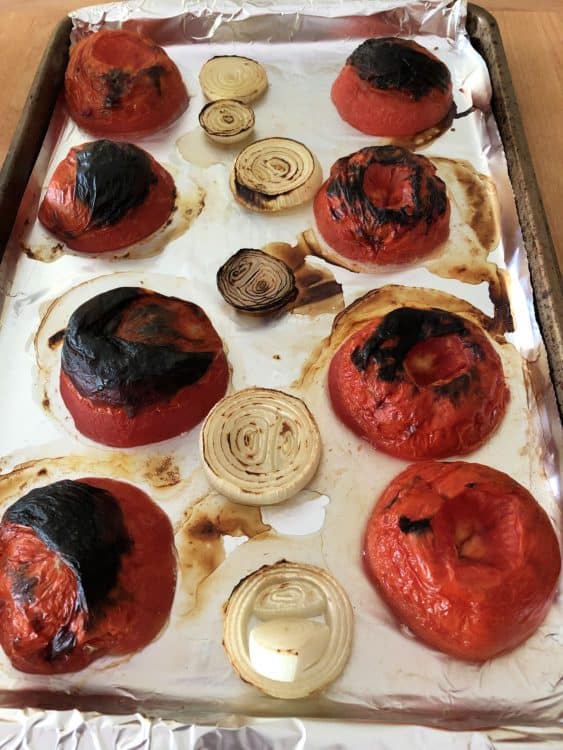 roasted tomatoes and onions on a baking sheet