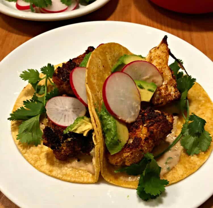 2 cauliflower tacos on a white plate