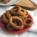 Air Fryer Frozen Onion rings on a small red plate