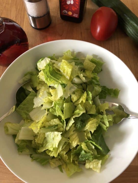 salad greens in a white bowl