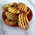 air fried waffle fries on a small red plate