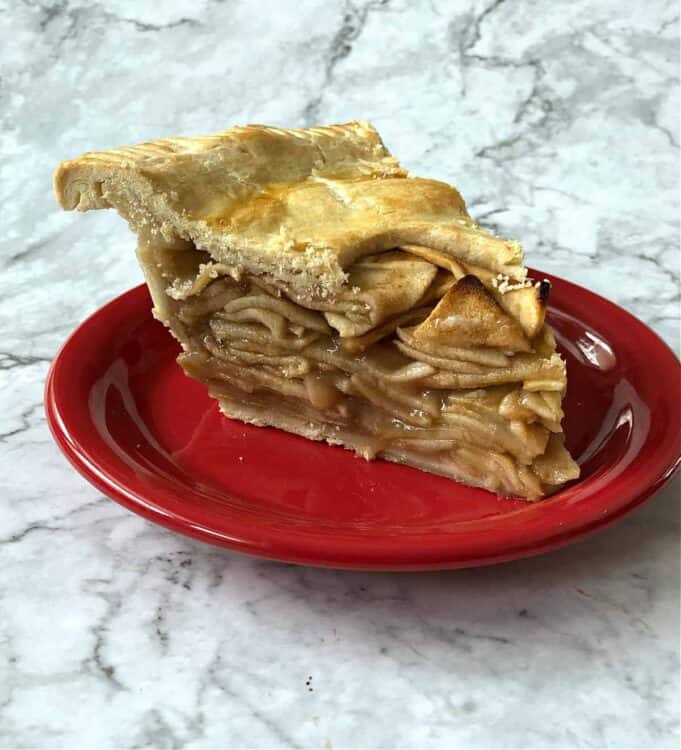 slice of apple pie on a red plate