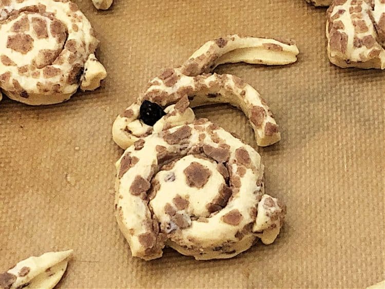 unbaked cinnamon roll shaped into a bunny