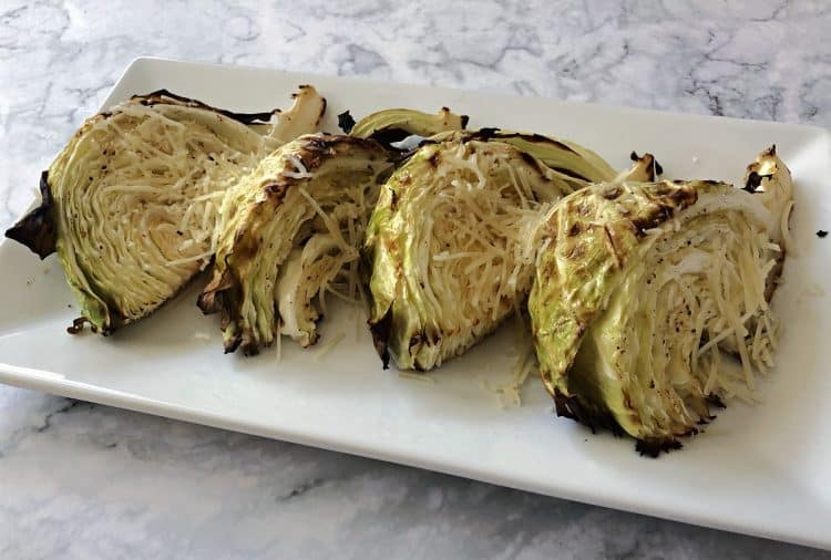 Roasted cabbage wedges on a white platter