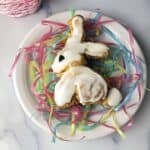 Easter bunny cinnamon roll on a white plate with pastel pretend grass