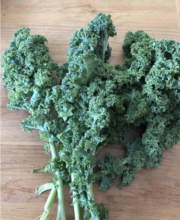 bunch of kale on a cutting board