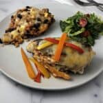 Fajita stuffed chicken on a plate with rice and a salad