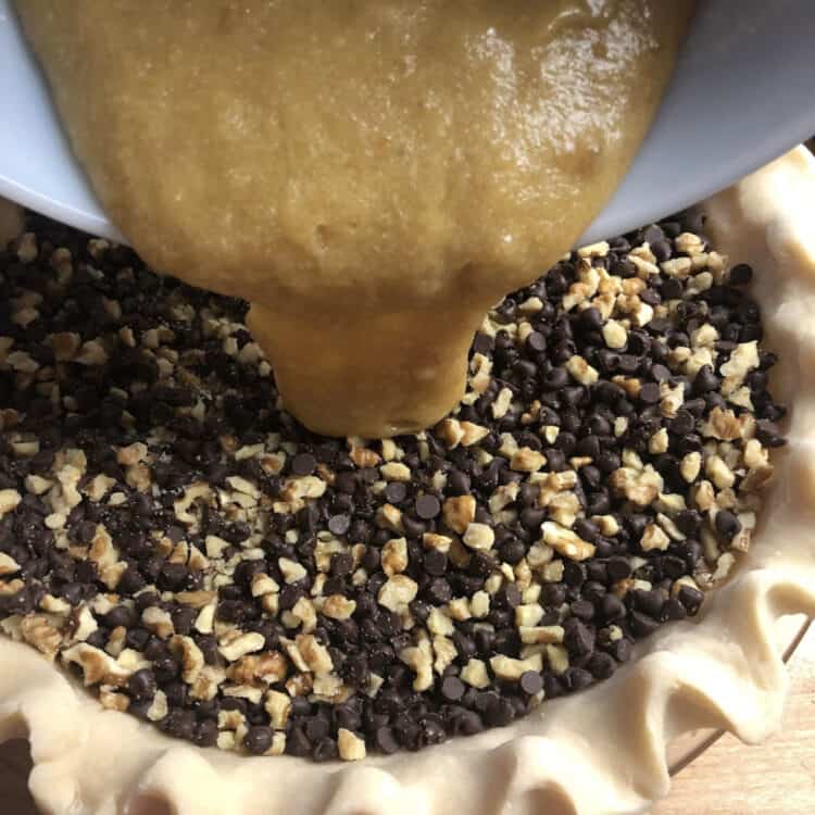 sugar mixture being poured into the pie crust