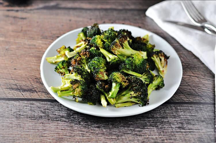 air fryer broccoli on a white plate, viewed from above