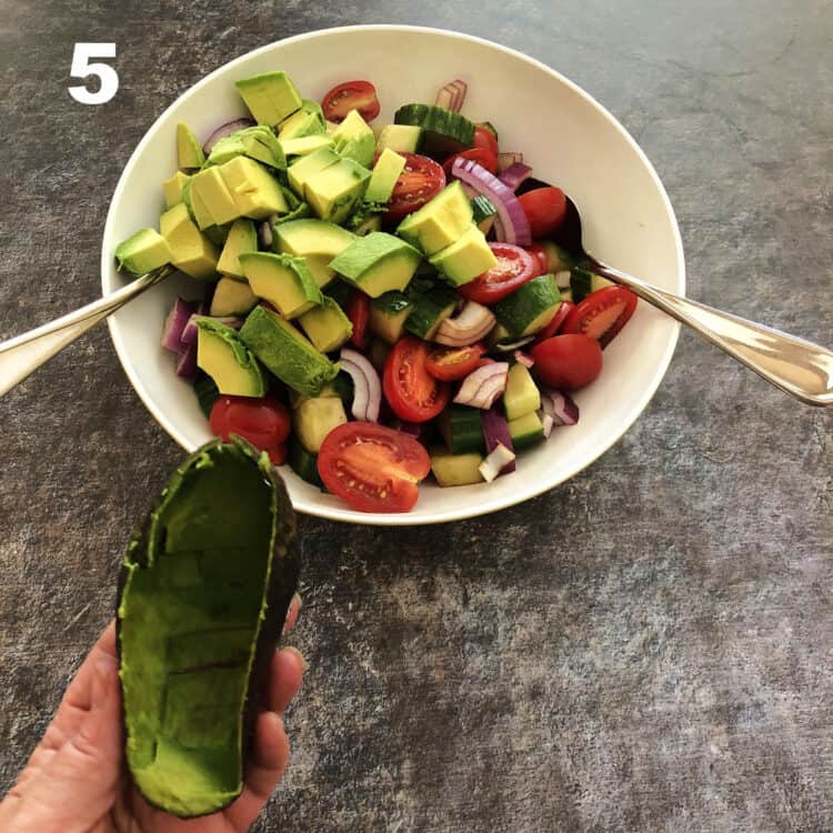 chunks of avocado added to the bowl