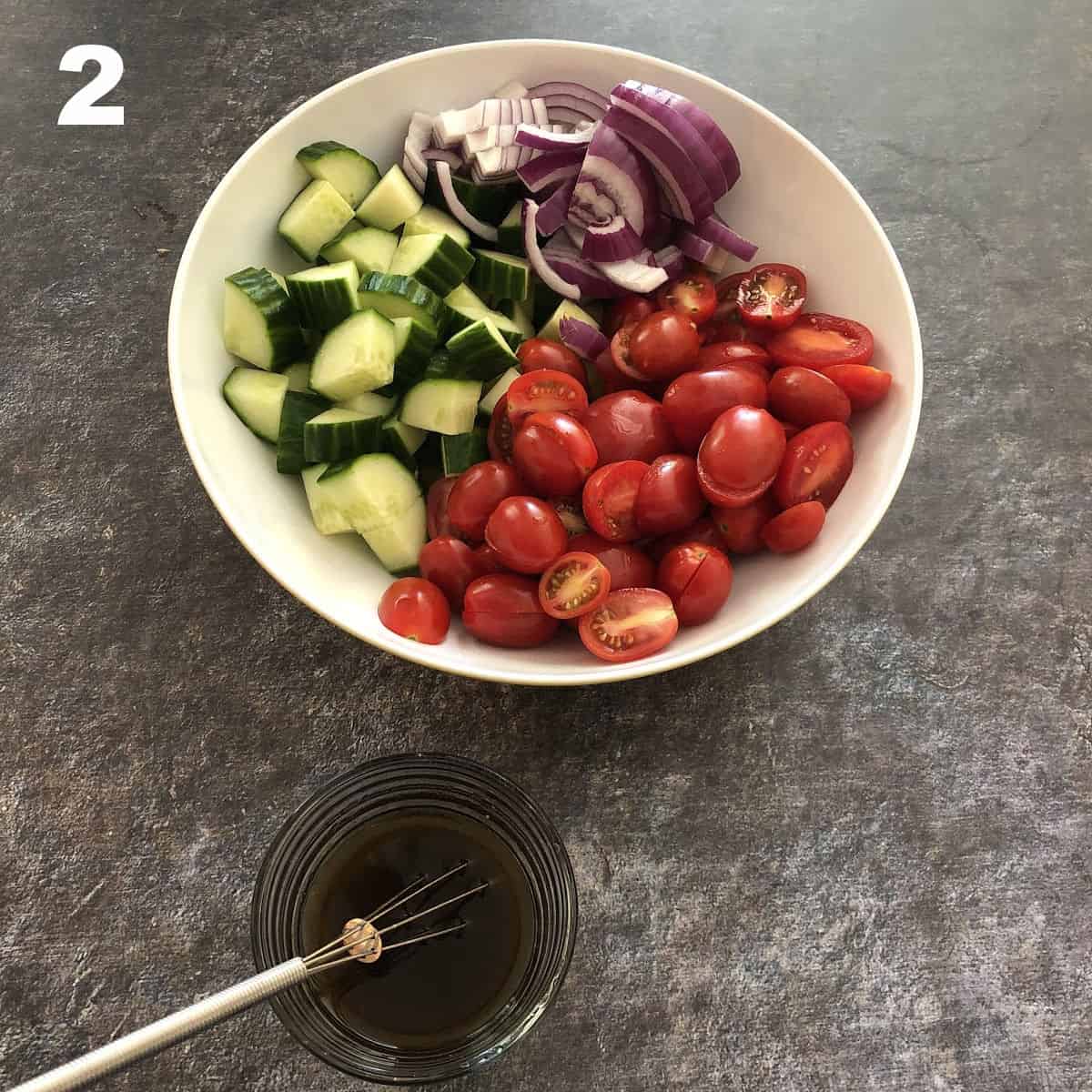 bowl of veggies with balsamic dressing nearby