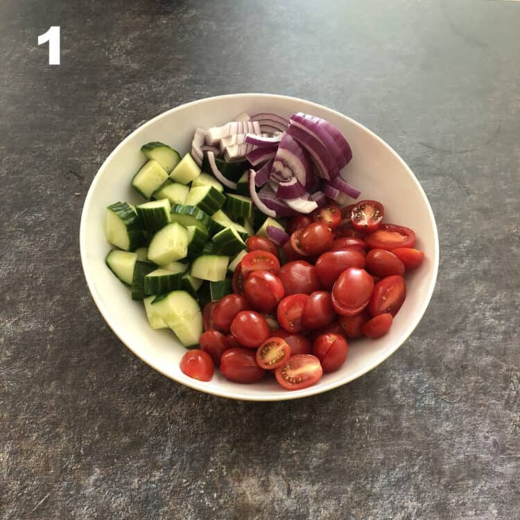 cucumbers tomatoes and onion in a bowl