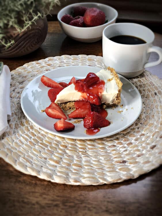 slice of cheesecake covered in berry sauce