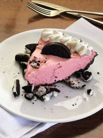 pink koolaid pie on a white plate
