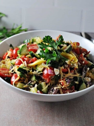 mediterraneam spaghetti squash salad in a serving bowl, looking from above