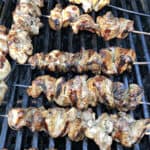 Chinese chicken on a stick (skewers) cooking on a BBQ grill