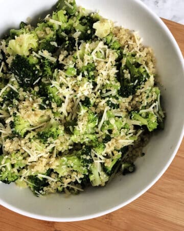 Quinoa with broccoli and parmesan in a white serving bowl