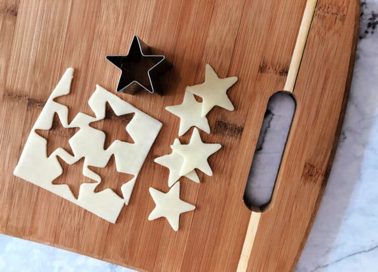 star cookie cutter making star shapes of cheese slices