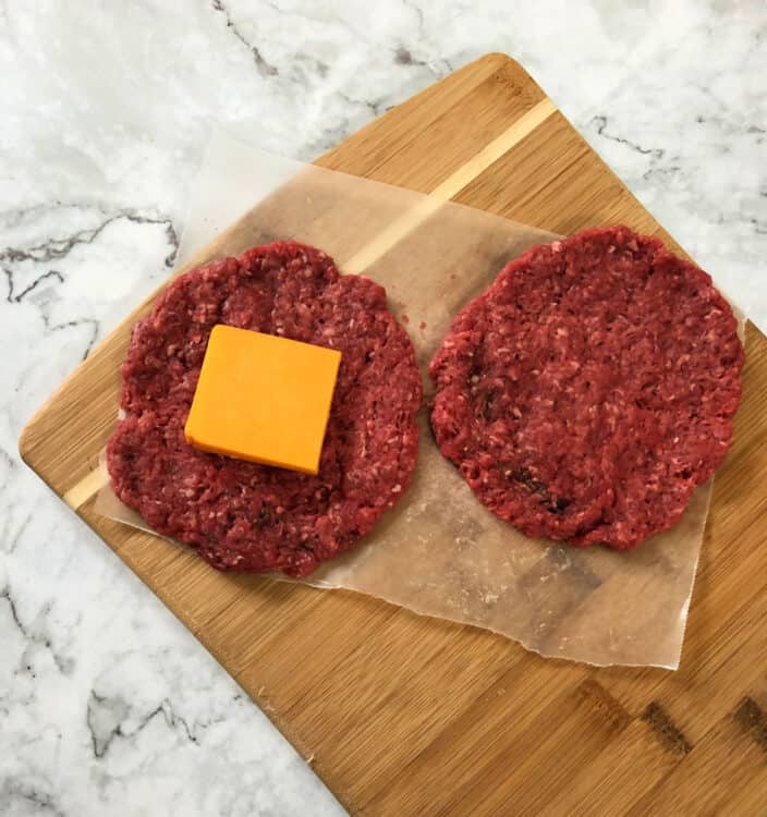 square of cheese added to one of the burger patties