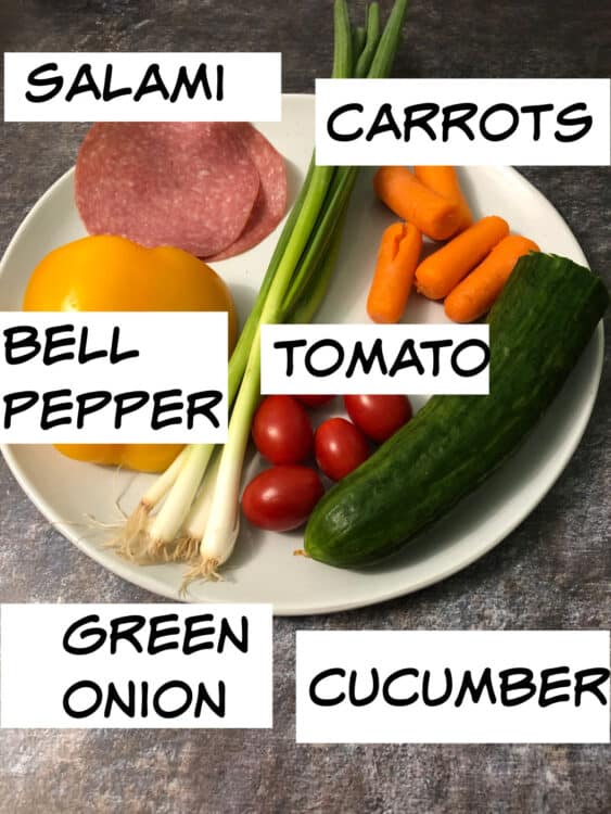 Ingredients before chopping: bell pepper, green onion, timatoes, carrots, cucumber and salami