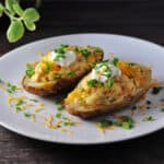 Grilled twice baked potatoes on a white plate