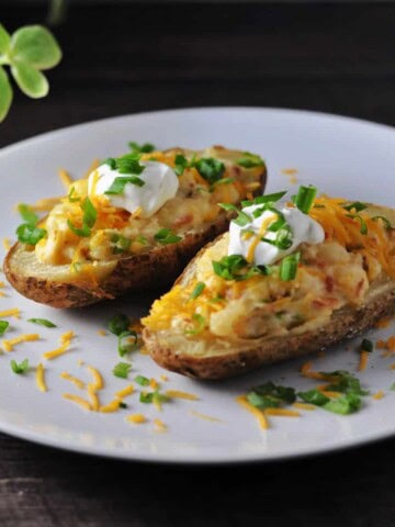 Grilled twice baked potatoes on a white plate