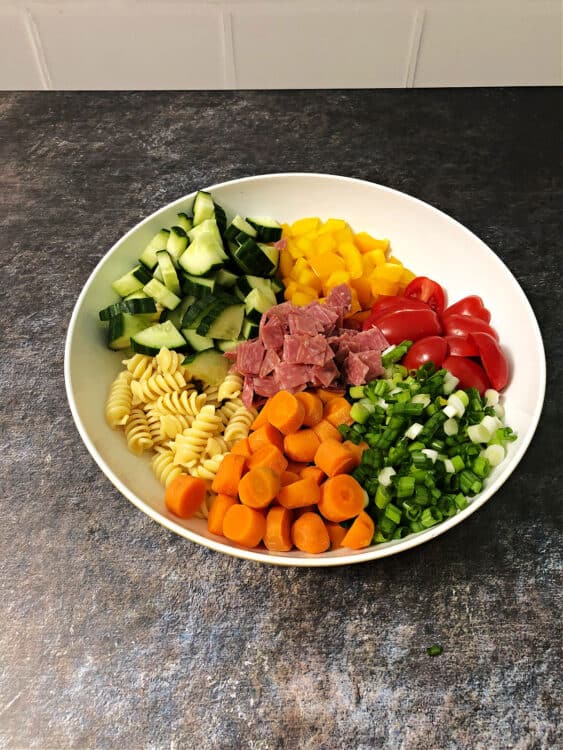 Pasta salad ingredients in a bowl