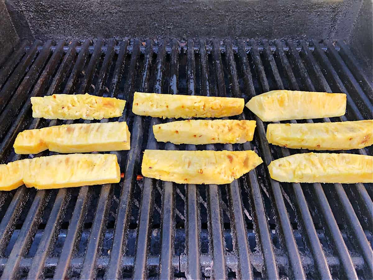 Pineapple spears cooking on the grill.