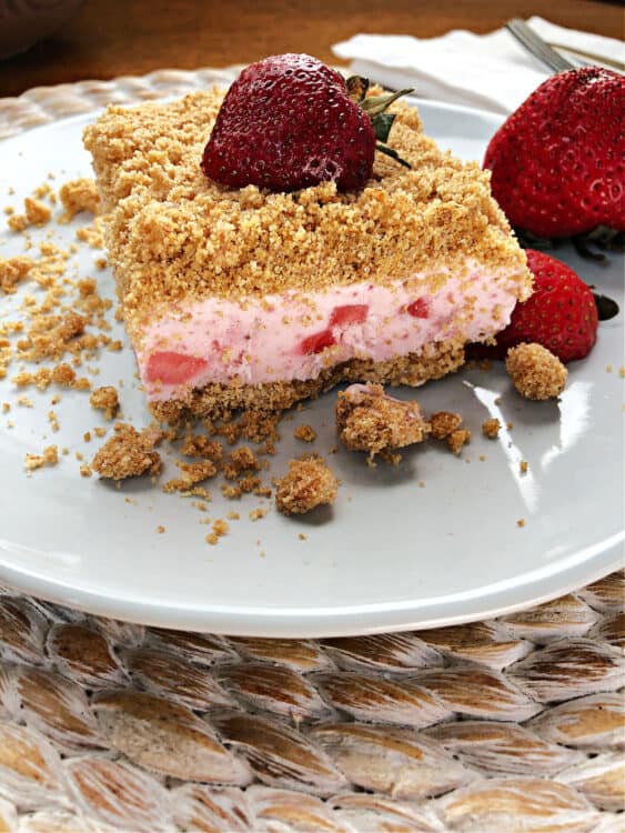 square of frozen strawberry dessert on a small white plate