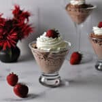 Easy chocolate mousse in a stemless martini glass topped with whipped cream and a strawberry