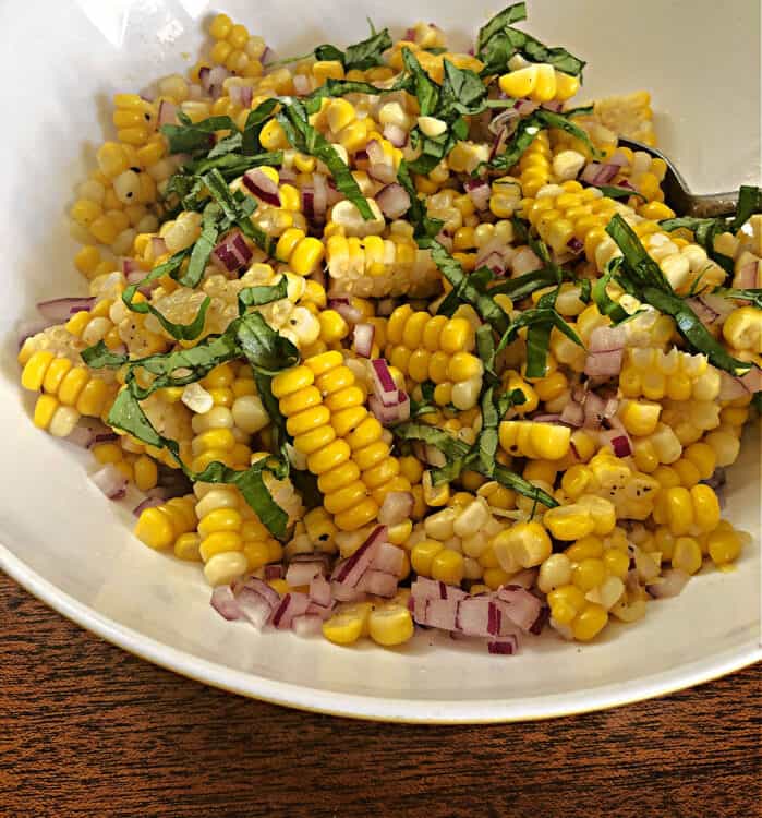 corn salad in a white bowl up close