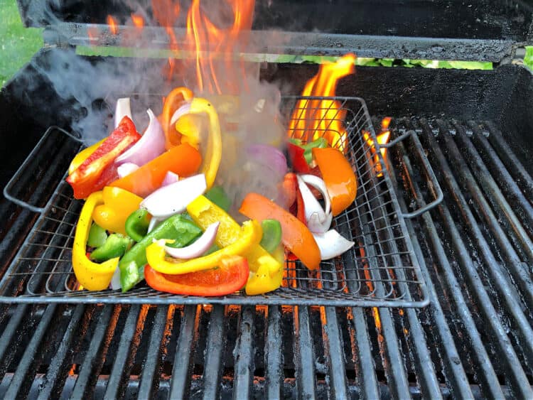 peppers on the grill engulfed by a large flame 