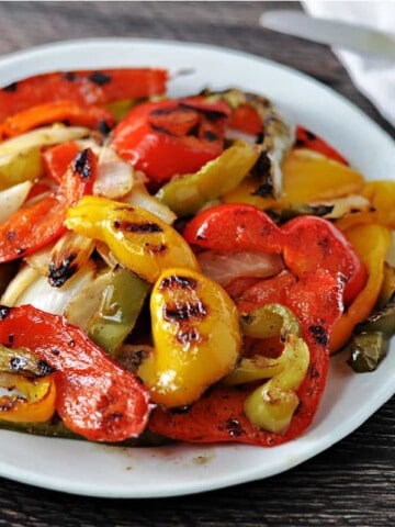 grilled bell peppers and onions on a white plate