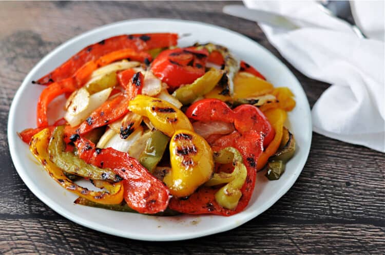 grilled bell peppers and onions on a white plate