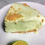 slice of frozen tropical lime pie on a white plate